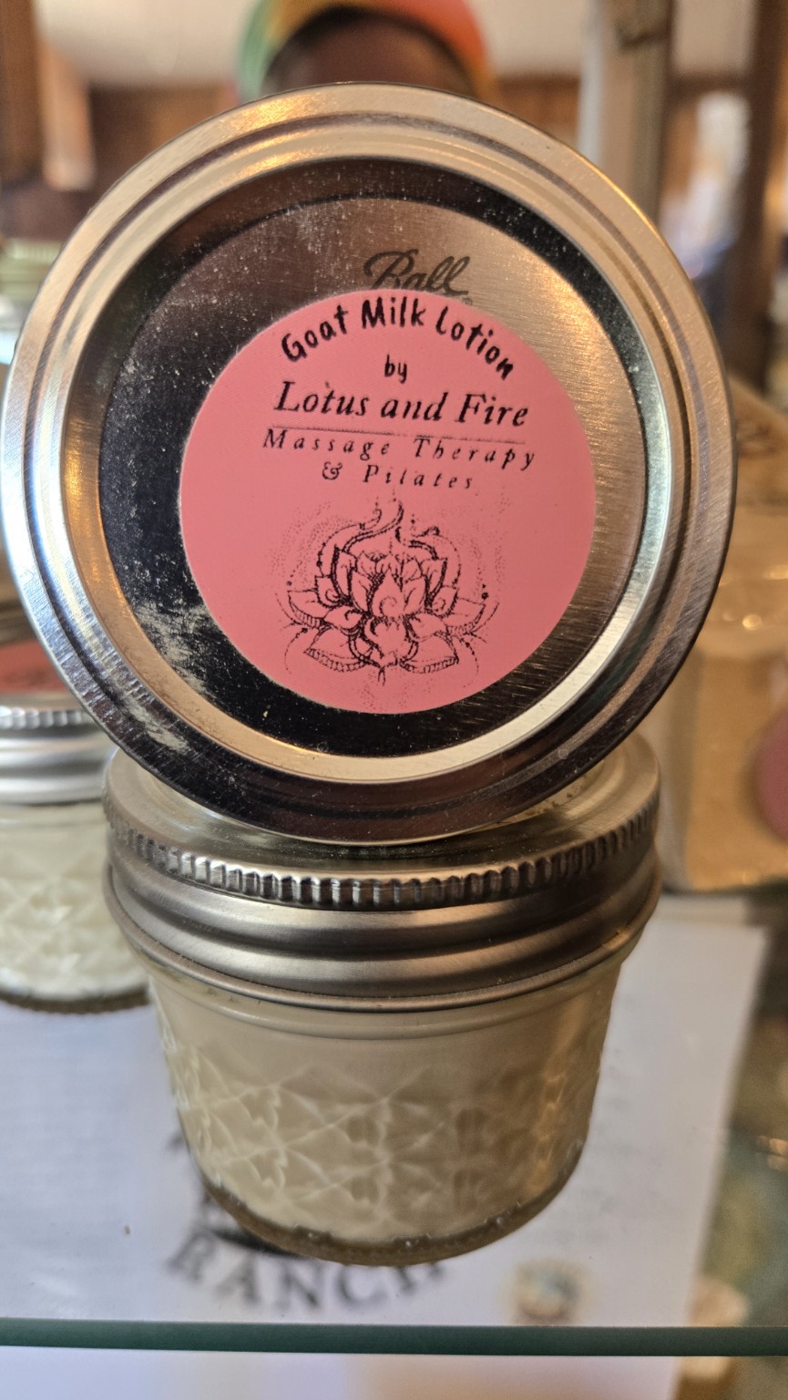 Lotus and Fire goat milk lotion in a glass jar
